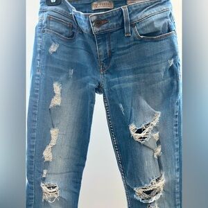 Guess distressed low rise skinny jeans. Size 27